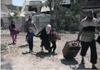  ?? Maya Alleruzzo / AP Photo ?? Families in west Mosul bear the brunt of fighting in the city and thousands have no option but to flee.