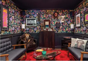  ?? (Vivian Johnson/banner Day Interiors via AP) ?? This photo provided by Clara Jung of Banner Day Interiors in San Francisco shows a cozy den with a vintage wood bar, a sprawl-worthy crimson rug, and Schumacher’s Exotic Butterfly wallpaper.