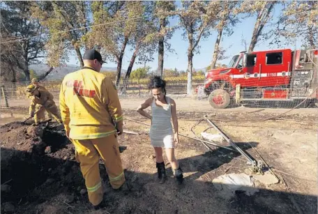  ?? Genaro Molina Los Angeles Times ?? SHUNNED by banks, many pot growers are stuck with cash. Ashley Oldham, above, found her savings turned to ash in a safe after the fire.