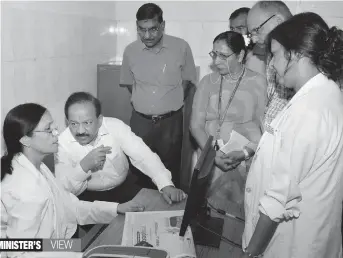  ?? — PTI ?? Union health minister Harsh Vardhan interacts with health officials during a visit to the CGHS dispensary at North Avenue in New Delhi on Monday.