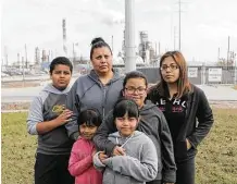  ?? Elizabeth Conley / Houston Chronicle ?? Sarahi Tovar is in her Manchester front yard with her children, from left, Abraham, 11, Marisa, 5, Marion, 7, Camila, 8, and Dalila, 16. Their house is across the street from a refinery.