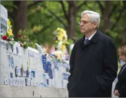 ?? BONNIE CASH — POOL PHOTO VIA AP ?? Attorney General Merrick Garland walks through The National Law Enforcemen­t Memorial on Friday in Washington. Garland laid a wreath at the memorial to honor fallen officers as part of National Police Week.