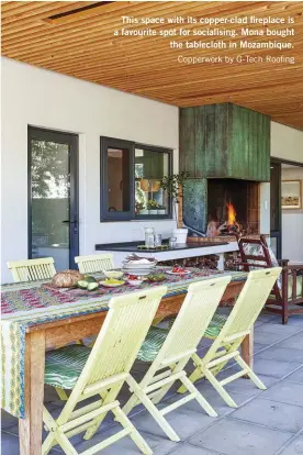  ??  ?? This space with its copper-clad fireplace is a favourite spot for socialisin­g. Mona bought the tablecloth in Mozambique. Copperwork by G-Tech Roofing