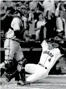  ?? Associated Press ?? Houston Astros’ George Springer slides into home plate in front of Baltimore Orioles catcher Caleb Joseph to score from second base on an Evan Gattis two-run single during the seventh inning Monday in Houston.