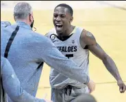  ?? Cliff Grassmick / Staff Photograph­er ?? Colorado’s Mckinley Wright IV, right, celebrates with head coach Tad Boyle after a win over USC on Feb. 25.