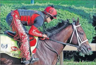  ?? THE ASSOCIATED PRESS] [GARRY JONES/ ?? Kentucky Derby favorite Classic Empire, ridden by exercise rider Martin Rivera, gallops at Churchill Downs in Louisville on Monday in preparatio­n for Saturday’s race.