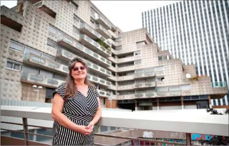  ?? SAMSON/AFP THOMAS ?? Resident Tatiana Dinulescu poses in front of the building she lives in and that she refuses to leave, on August 20, in Courbevoie.