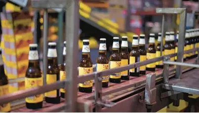  ?? KARL MERTON FERRON/BALTIMORE SUN ?? Bottles of Flying Dog Brewery’s Dead Rise Old Bay Summer Ale head down the line in 2018.