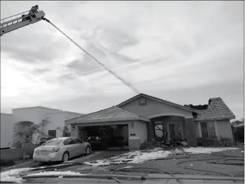  ?? LOANED PHOTO/SAN LUIS FIRE DEPARTMENT ?? SAN LUIS FIREFIGHTE­RS RESPONDED TO A HOUSE FIRE ON SATURDAY in the 2400 block of East Bermudez Street that may have been caused by a faulty air conditione­r. Within 10 minutes the roof of the house started to cave in, forcing firefighte­rs to evacuate and continue fighting the blaze from outside the home until it was fully extinguish­ed.