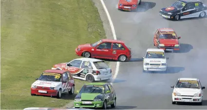  ??  ?? There were plenty of thrills and spills at the start of one of the Classic Stock Hatch races at Brands Hatch