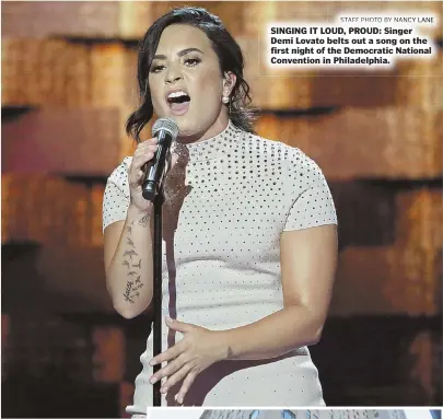  ?? STAFF PHOTO BY NANCY LANE ?? SINGING IT LOUD, PROUD: Singer Demi Lovato belts out a song on the first night of the Democratic National Convention in Philadelph­ia.