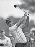  ?? ERIC SUCAR/USA TODAY SPORTS ?? Tiger Woods hits his tee shot on the 12th hole during Friday’s second round of the BMW Championsh­ip golf tournament at Aronimink Golf Club.