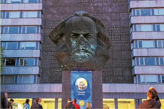 ?? AP ?? A video installati­on illuminate­s the Karl Marx Monument in Chemnitz, eastern Germany – including US President Donald Trump symbolical­ly congratula­ting him. Chemnitz, along with Marx’s birthplace of Trier in western Germany, is marking the philosophe­r’s...