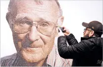  ?? OLA TORKELSSON/TT VIA THE ASSOCIATED PRESS ?? A visitor takes a photo of the founder of the Swedish furniture retailer IKEA, Ingvar Kamprad, on Sunday at the IKEA museum, in Almhult, Sweden. The portrait of Kamprad on the wall is made out of a big amount of small portraits of employees. Kamprad...