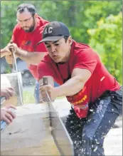  ??  ?? Connor Morse (foreground) and Geoff Larkin compete in the single buck at the Nova Scotia Lumberjack Championsh­ips.