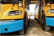  ?? NYT ?? Electric school buses Sept. 11 in South Burlington, Vt. The buses are a test of the idea that electric vehicles could be a buffer that soaks up power when there is too much and provides it when demand for electricit­y surges.