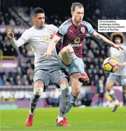  ??  ?? Chris Smalling challenges Ashley Barnes during United’s match at Burnley