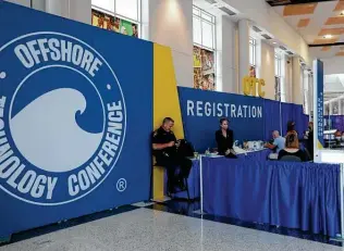  ?? Karen Warren / Staff photograph­er ?? Workers prepare the registrati­on desk for the OTC’s opening day Monday. Officials are remaining mum about this year’s attendance for the first time in the event’s 52-year history.