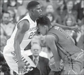  ?? AP/JAMES CRISP ?? Kentucky’s Alex Poythress (left) defends Mississipp­i’s Sebastian Saiz during the second half of the No. 10 Wildcats’ 83-61 victory over the Rebels on Saturday at Rupp Arena in Lexington, Ky.