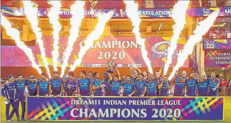  ?? PTI ?? Mumbai Indians players with the winners’ trophy after their title triumph over Delhi Capitals in the Indian Premier League on Tuesday.