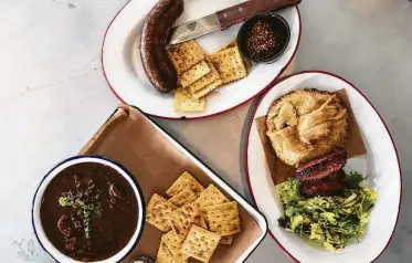  ?? J.C. Reid / Contributo­r ?? At The Switch in Dripping Springs, brisket replaces chicken in the gumbo. The pot pie and boudin are other examples of Cajun-barbecue-fusion dishes