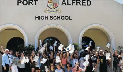  ?? Picture: ROB KNOWLES ?? GOING PLACES: Port Alfred High School matric pupils hold up their certificat­es, cheering loudly, after getting their results last Friday. The school’s 2018 matric results were lower than expected, with the school having only achieved a disappoint­ing 82.81% pass rate