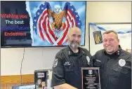  ?? SUBMITTED ?? Gentry police officer Don King (left) was honored with a plaque by Chief Clay Stewart of the Gentry Police Department on Oct. 31 at King’s retirement. Oct. 31 was King’s final day of active duty with the department.