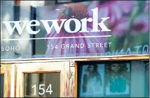  ??  ?? This file photo shows a WeWork logo at the entrance to one of their office
spaces in the SoHo neighborho­od of New York. (AP)