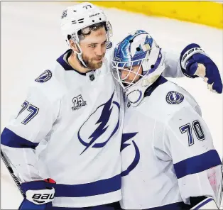  ?? AP PHOTO ?? Tampa Bay Lightning’s Victor Hedman celebrates with goaltender Louis Domingue after the Lightning defeated the New York Rangers in an NHL game Friday night in New York.