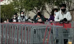  ?? ANDA CHU — STAFF ARCHIVES ?? Customers line up to get into a Costco in Hayward in April 2020. On Tuesday, the last remnants of California's COVID-19state of emergency expired.