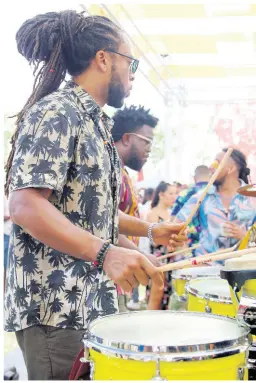  ??  ?? Popular Trinidadia­n drum duo, Boom Boom Room, Modupe Onilu (left) and Rhys Thompson are caught up in the rhythms at Mimosa Breakfast Party held during Barbados Crop Over season.