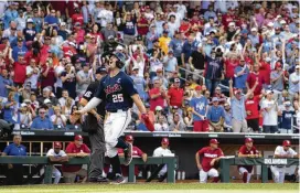  ?? REBECCA S. GRATZ / AP ?? Mississipp­i’s Tim Elko (25) celebrates being driven in by Kevin Graham against Oklahoma in the first game of the College World Series finals Saturday.