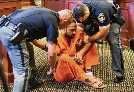  ?? NICK GRAHAM/STAFF ?? Gurpreet Singh, the West Chester man facing four counts of capital murder, fell while at the podium during his arraignmen­t Monday and was helped up by sheriff’s deputies.