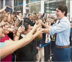  ?? — AP ?? Man of the hour: Trudeau greeting supporters in downtown Manila.