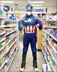  ?? PHOTO COURTESY JOHN PATRICOLO ?? Skippack Pharmacy’s Owner and Pharmacist Mayank Amin dons a superhero costume inside of the store.