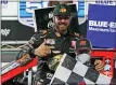  ?? STEVE HELBER — THE ASSOCIATED PRESS ?? Martin Truex Jr. gives a thumbs-up as he celebrates with a fan after winning a NASCAR Cup Series race at Martinsvil­le Speedway in Martinsvil­le, Va. last Sunday.