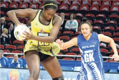  ?? COLLIN REID PHOTO COURTESY OF PETROJAM, SUPREME VENTURES, COURTS AND SCOTIABANK ?? Jamaica’s goal shooter, Jhaniele Fowler-Reid (left), collects the ball ahead of Samoa defender Natalie Jones at the Allphones Arena in Sydney, Australia, in their opening game of the 2015 Netball World Cup yesterday. Jamaica won 90-44.