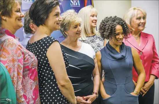  ?? Andrew Rush/Post-Gazette ?? Linda McMahon, administra­tor of the U.S. Small Business Administra­tion, center, poses with Kiya Tomlin and other small business owners after a roundtable discussion Monday at the agency's office Downtown. Ms. McMahon plans to visit all local offices...