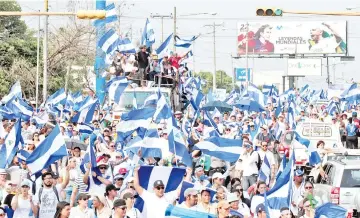  ??  ?? Demonstrat­ors take part in a protest march against Nicaraguan President Daniel Ortega’s government in Managua, Nicaragua. —Reuters photo