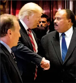  ?? AP/ANDREW HARNIK ?? President-elect Donald Trump shakes hands with Martin Luther King III, the son of civil-rights leader Martin Luther King Jr., on Monday at Trump Tower in New York.
