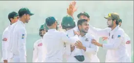  ?? AFP ?? Bangladesh’s Shakib Al Hasan (R) congratula­tes Mehidy Hasan (2nd R) during the second Test.
