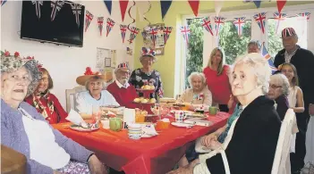  ??  ?? Social gatherings organised by Contact the Elderly volunteers help people to form new friendship­s. Sometimes, they have a special theme, like this royal wedding gathering last year, co-ordinated by Maggie Farmer, centre,