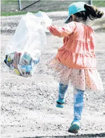  ?? ?? A young girl carries a bag of trash during last year’s Earth Weekend event in Yarmouth.