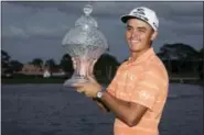  ?? MICHAEL ARES — THE PALM BEACH POST VIA AP ?? Golfer Rickie Fowler holds up the Honda Classic trophy after the conclusion of the golf tournament in Palm Beach Gardens, Fla., on Sunday.
