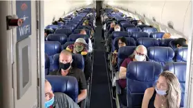  ?? Christophe­r Reynolds/Los Angeles Times/TNS ?? ■ Masked passengers fill a Southwest Airlines flight from Burbank, Calif., to Las Vegas on June 3, with middle seats left open.