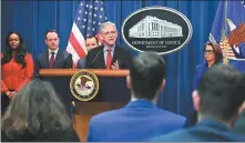  ?? MANDEL NGAN / AFP ?? US Attorney General Merrick Garland (center) answers questions during a news conference announcing an antitrust lawsuit against Apple at the Justice Department in Washington on Thursday.