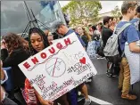  ?? GERALD HERBERT / ASSOCIATED PRESS ?? Stoneman Douglas High students wait to board buses Tuesday in Parkland, Fla., for a trip to the state’s capital, where they plan to pressure legislator­s on gun safety.