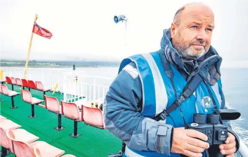  ??  ?? WATCHING BRIEF: Wildlife officer Andy Gilbert on the lookout in The Minch to catalogue more marine mammals for the CalMac programme