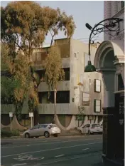  ??  ?? A copper oxide coating applied to the scalloped precast concrete facade compliment­s the silvergree­n canopies of the park’s ironbark gum trees.