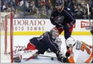  ?? JAY LAPRETE — THE ASSOCIATED PRESS ?? Columbus Blue Jackets goalie Sergei Bobrovsky, left tries to cover the puck as teammate Seth Jones and the Philadelph­ia Flyers’ Chris VandeVelde look for the rebound during the first period. The Flyers lost 1-0.